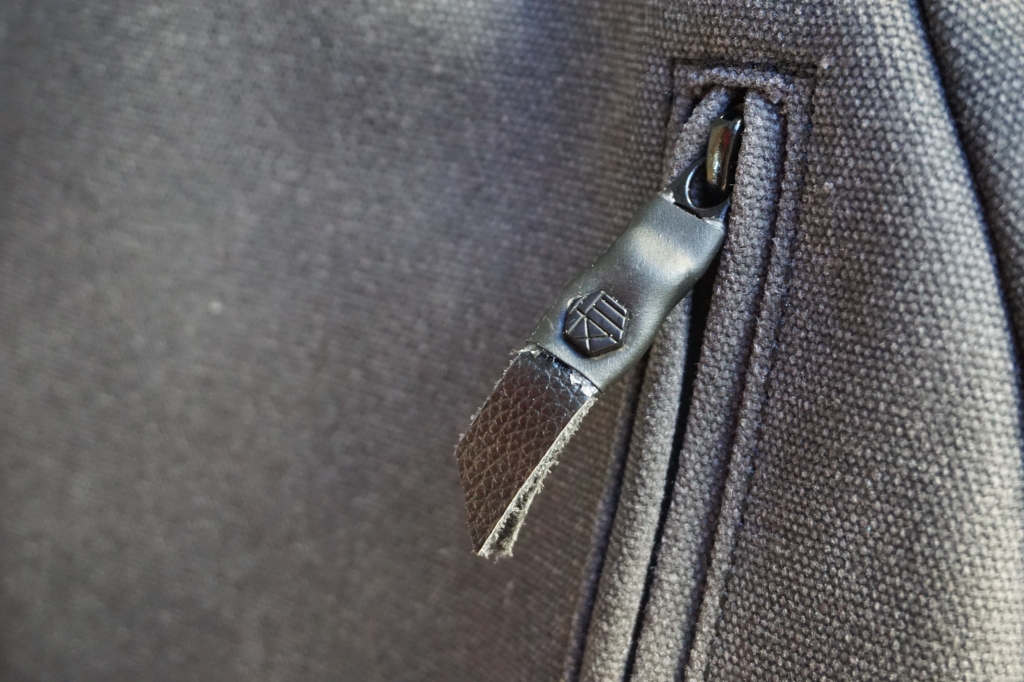 Hex brand supply signal backpack front pocket zipper logo detail view